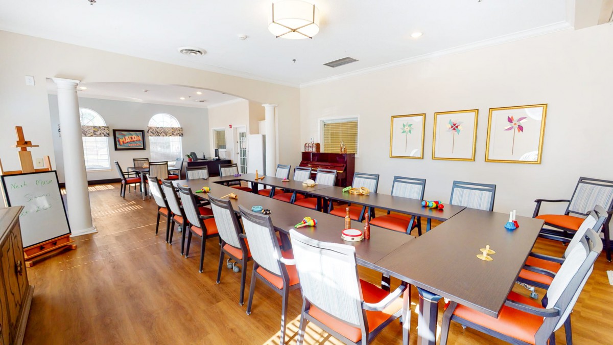 A modern conference room with a long meeting table and chairs arranged neatly.