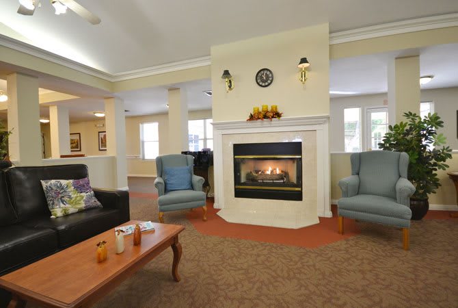 A cozy living room with a fireplace and comfortable seating.