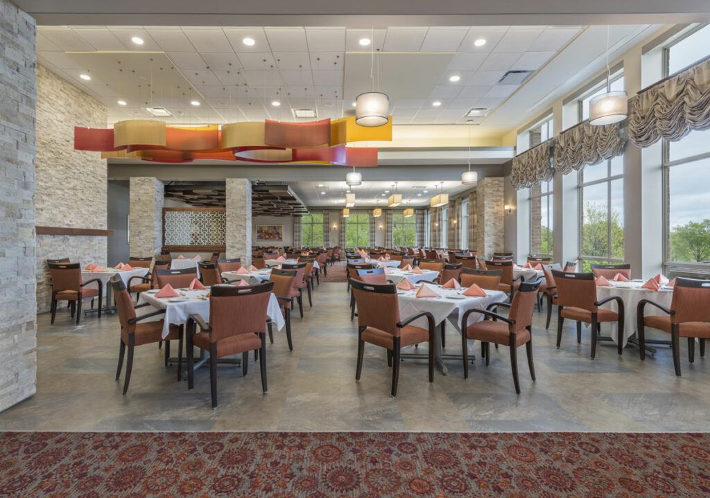 An elegant dining area with neatly arranged tables and chairs, ready for guests.