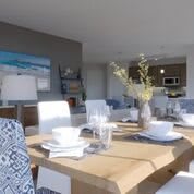 A modern dining room with a stylish table setting and bright, airy decor.