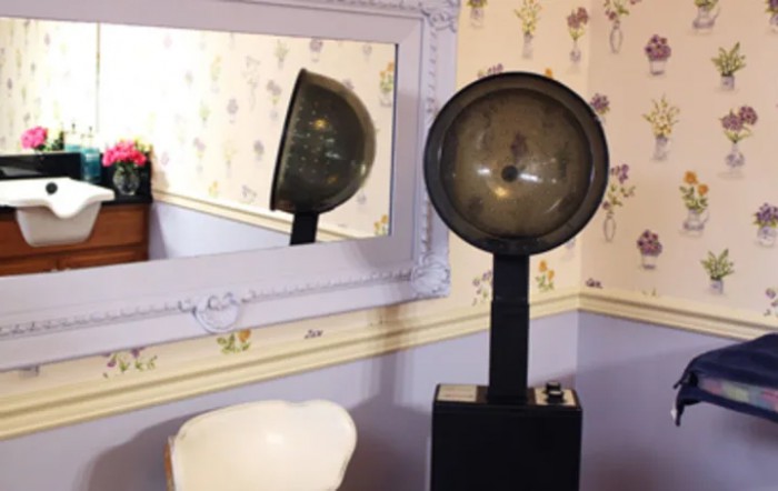 A vintage lamp reflected in a wall mirror, adding a classic touch to the room decor.