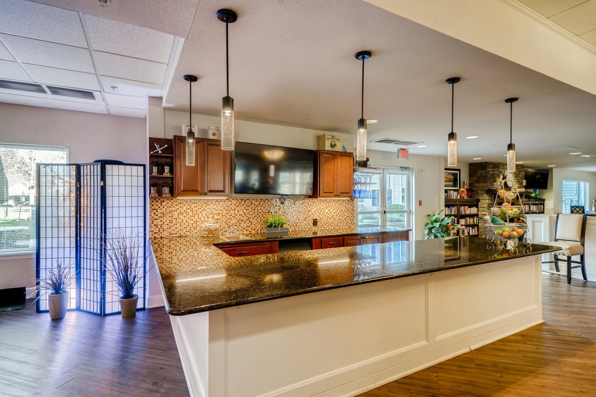 A modern kitchen with a spacious countertop and elegant pendant lighting.
