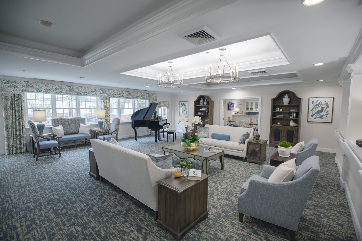 A luxurious living room with elegant furnishings and a grand piano.