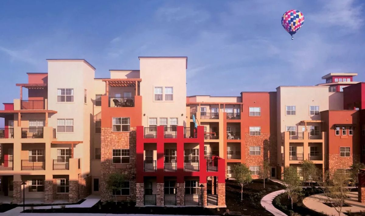 A modern apartment building with vibrant colors and balconies.