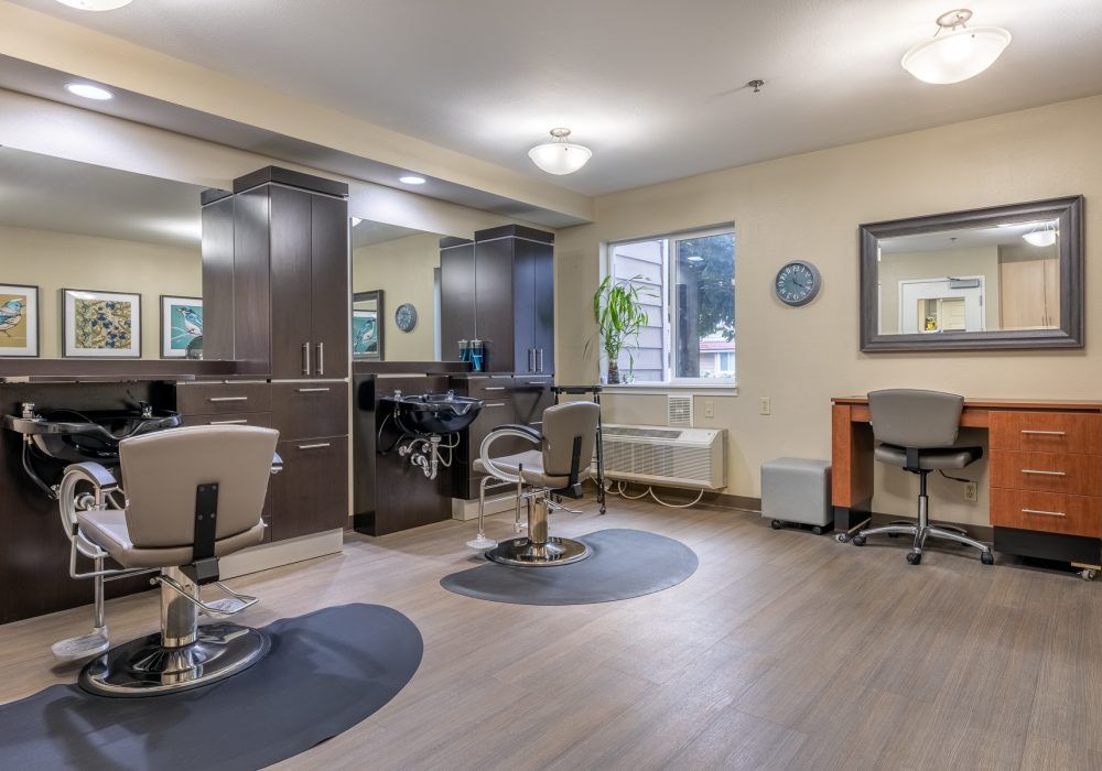 A modern hair salon interior with chairs and mirrors.