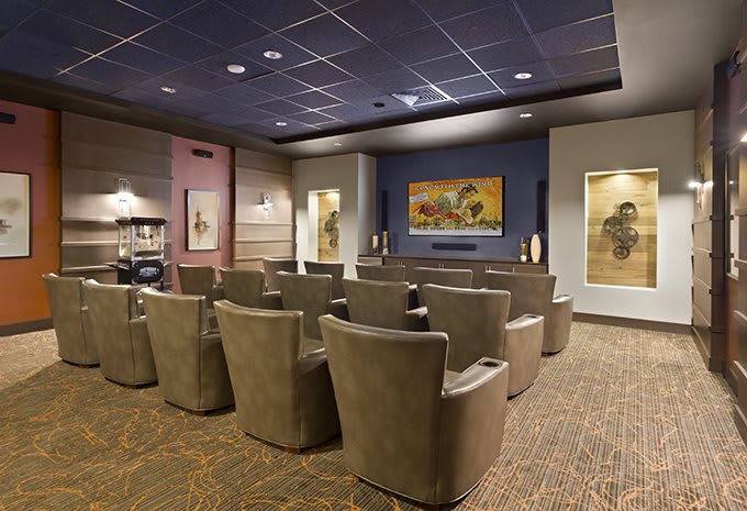 A small theater room with comfortable seating and a large screen.