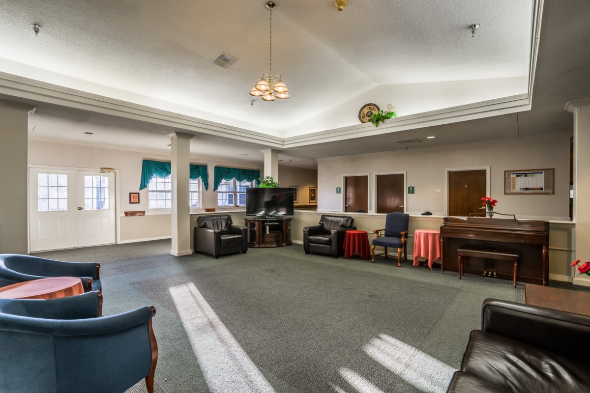 A spacious living room with comfortable seating and a television.