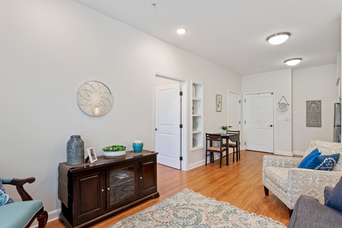 A cozy living room with hardwood floors, stylish decor, and modern furniture.