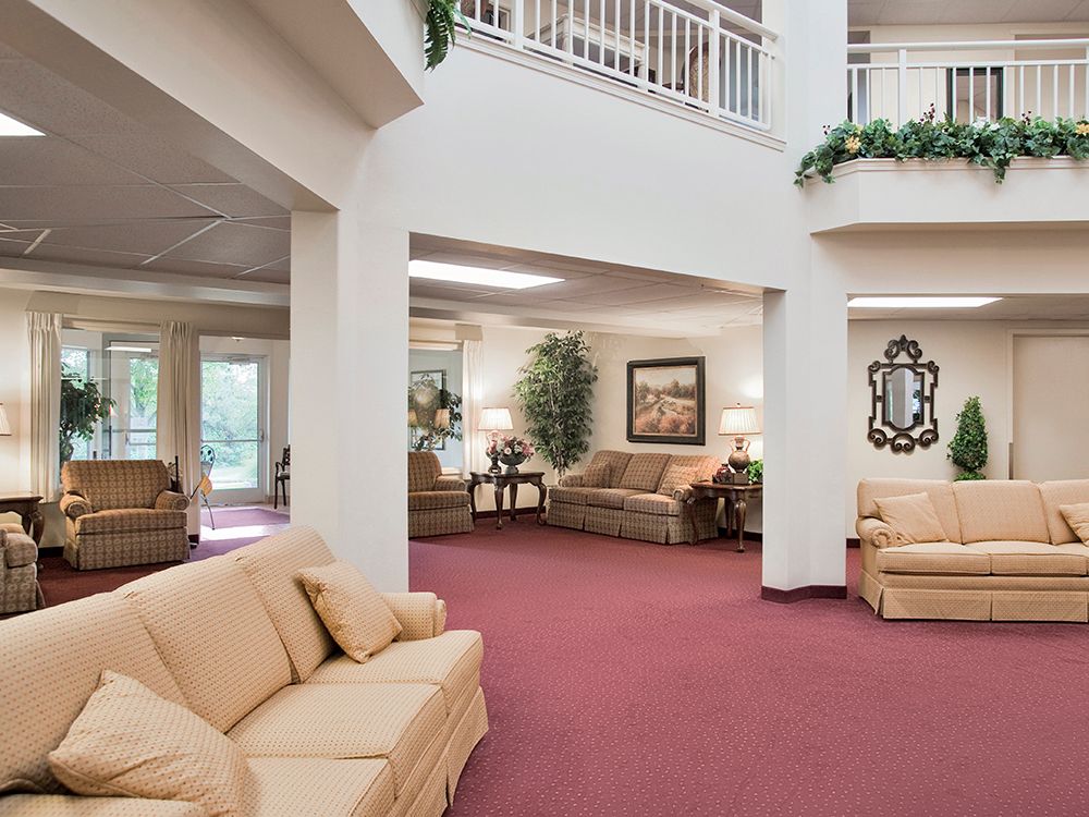 A spacious lobby area featuring comfortable sofas, artwork, and decorative elements.