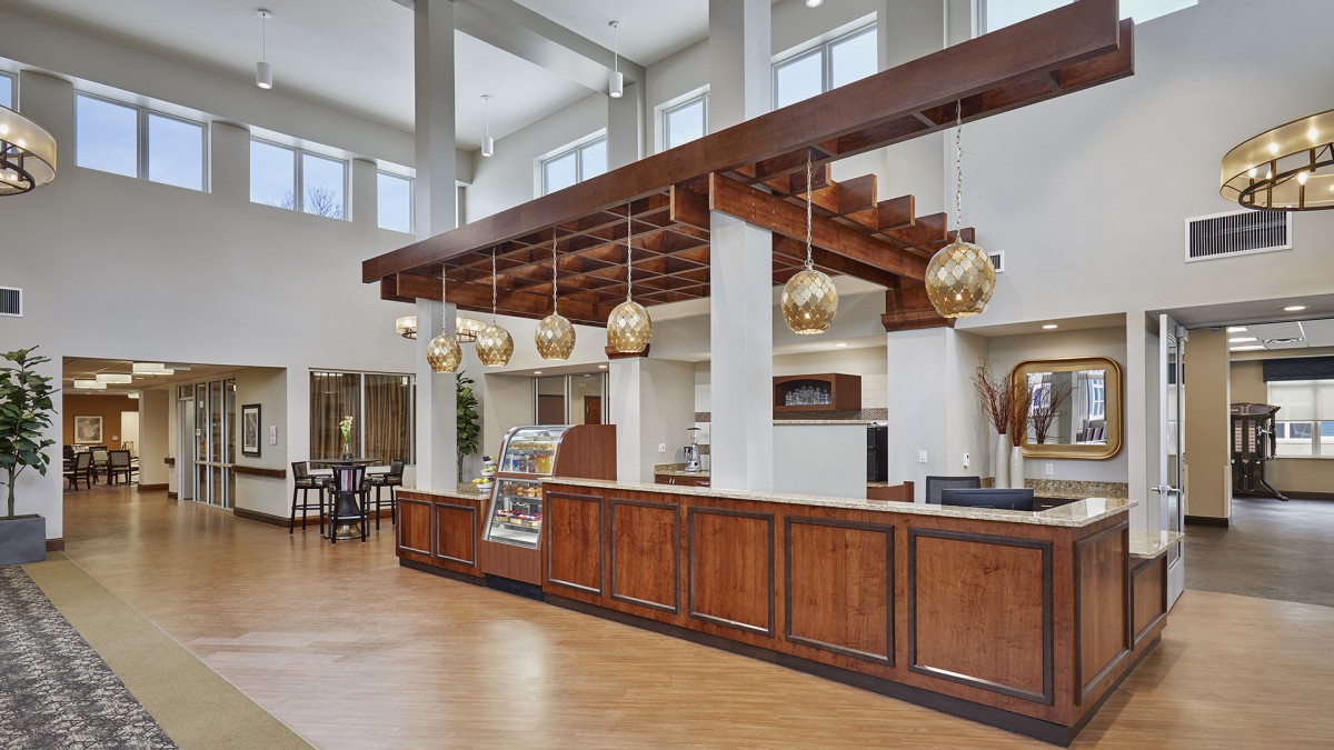 A modern coffee shop interior with wooden accents and stylish lighting fixtures.
