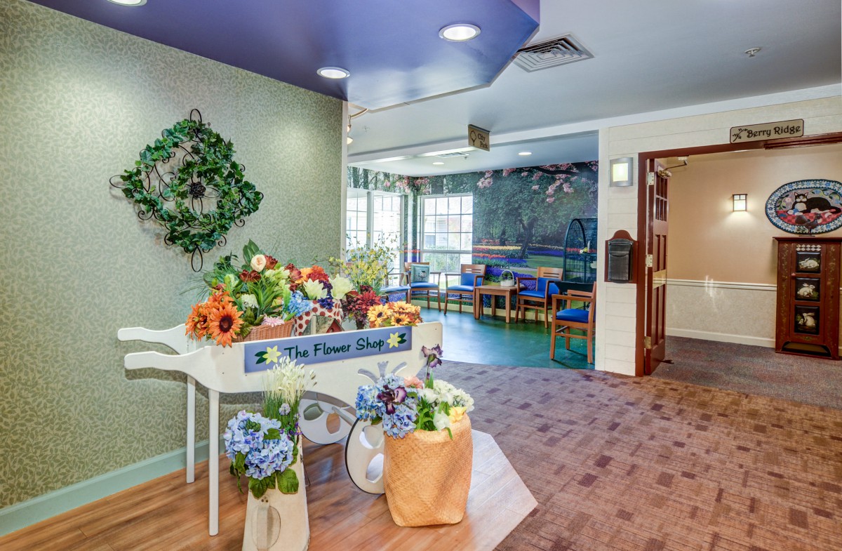 A bright and colorful children's playroom with floral decorations and seating.