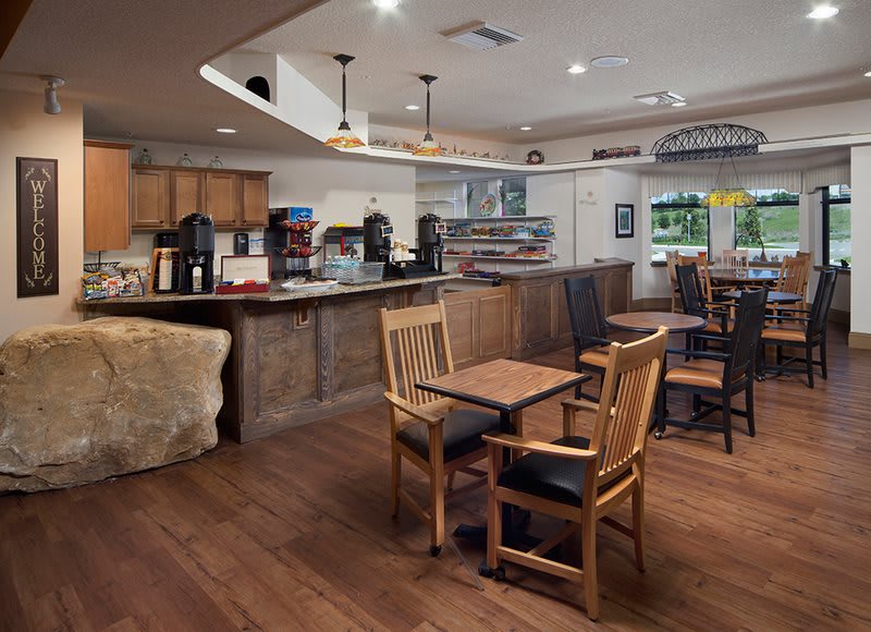 A cozy cafe interior with wooden furniture and a welcoming atmosphere.