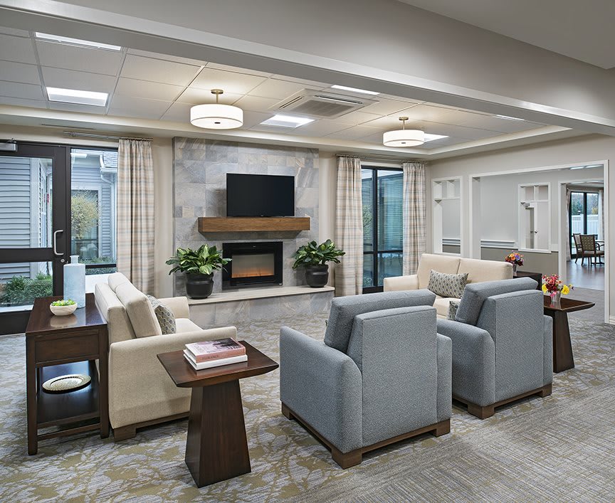 A modern living room with comfortable seating, a fireplace, and a television.