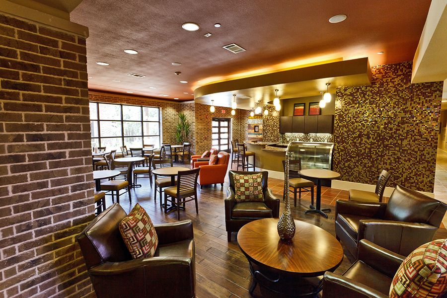 A modern, cozy cafe interior with comfortable seating and warm lighting.