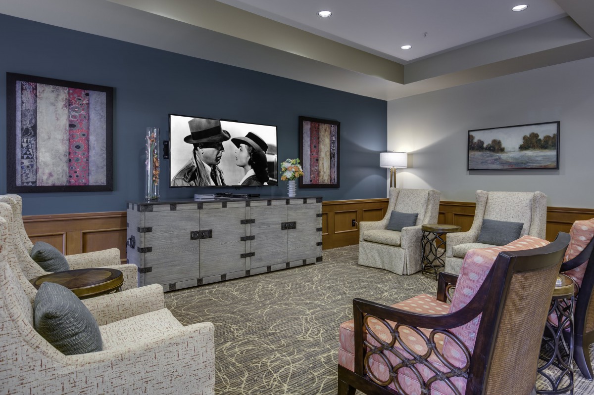 A modern living room with stylish furniture and a wall-mounted television.