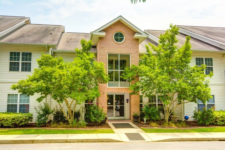 A suburban residential building surrounded by greenery.