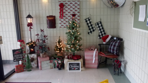 A charming holiday corner decorated for Christmas with twinkling lights, a festive tree, and wrapped gifts.