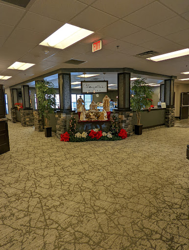 A spacious and well-decorated office lobby featuring plants and a welcoming reception area.