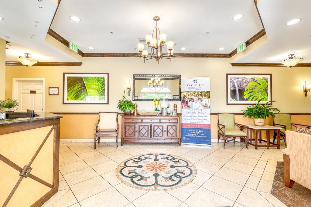 A well-decorated lobby with a chandelier, artwork, and comfortable seating.