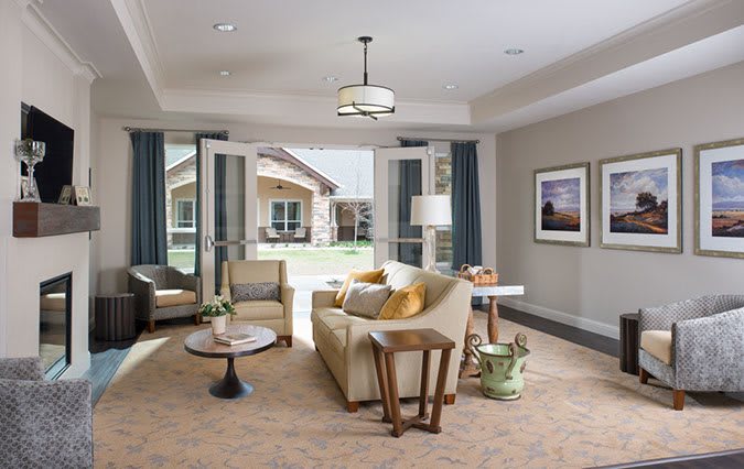 A modern living room with stylish furniture and large windows allowing natural light.