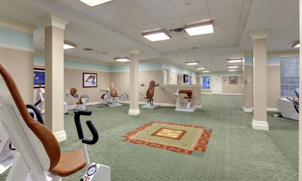 A spacious gym interior with fitness equipment and a carpeted floor.