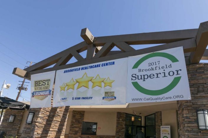 A storefront displaying banners showcasing awards and recognitions.