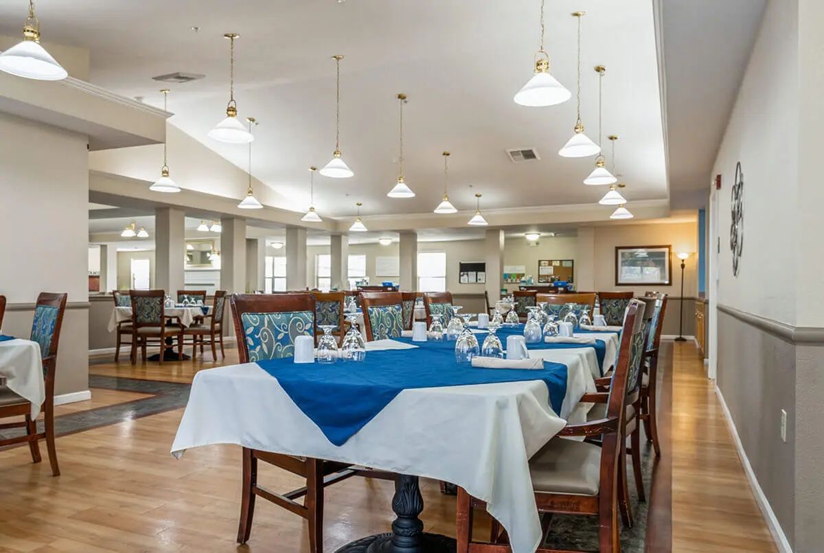 A well-arranged dining area with neatly set tables and modern lighting.