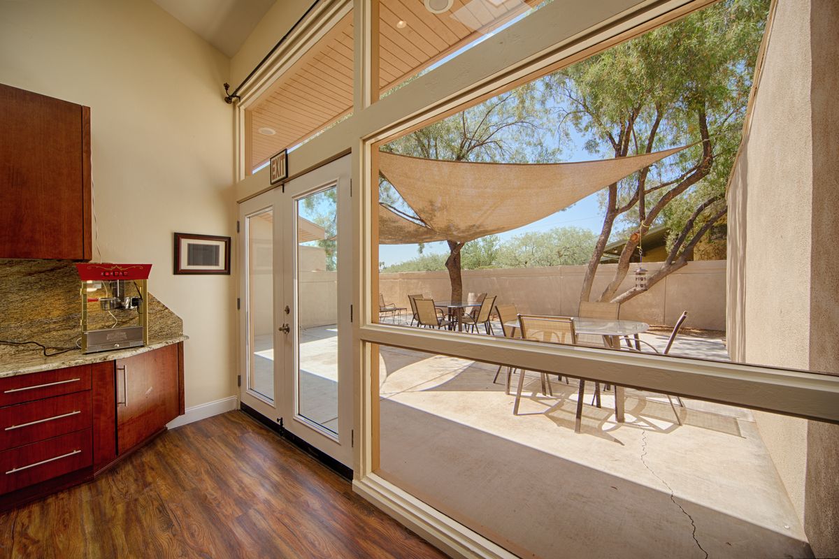 Spacious living area with large windows and a view of the patio.
