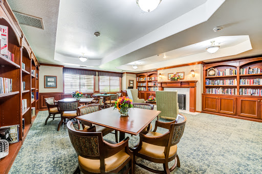 A cozy and inviting community lounge with comfortable seating and a fireplace, ideal for social gatherings or quiet reading.