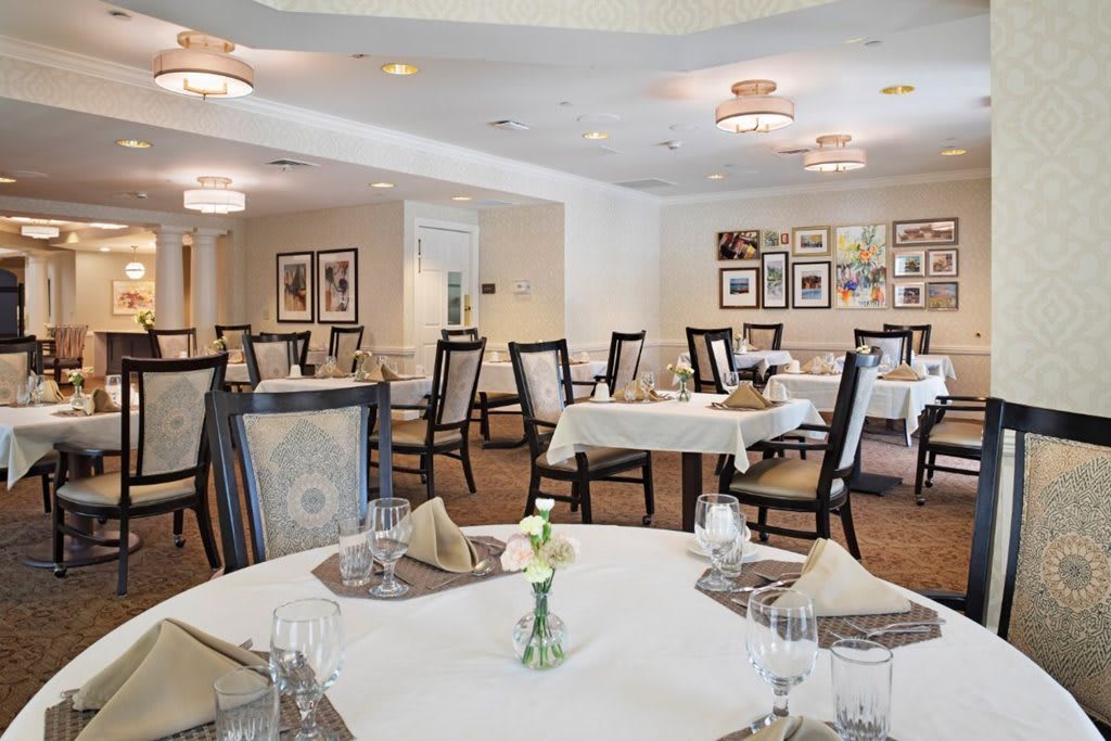 An elegant dining room with neatly arranged tables and chairs, ready for guests.
