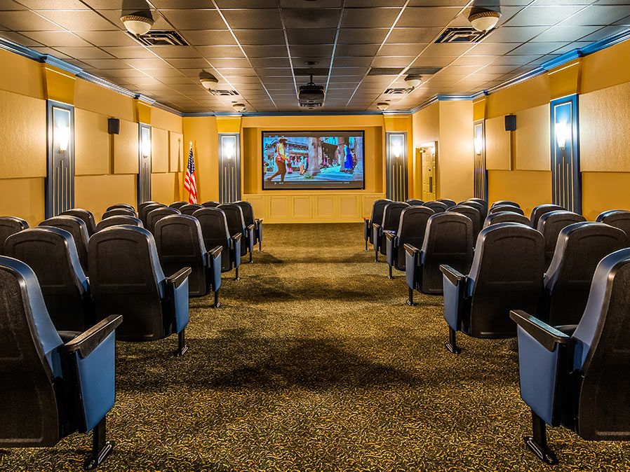 A cozy home theater setup with comfortable seating and a large screen.