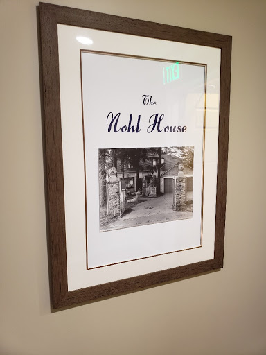 A framed historical photograph of the Nohl House, showcasing its architectural details.