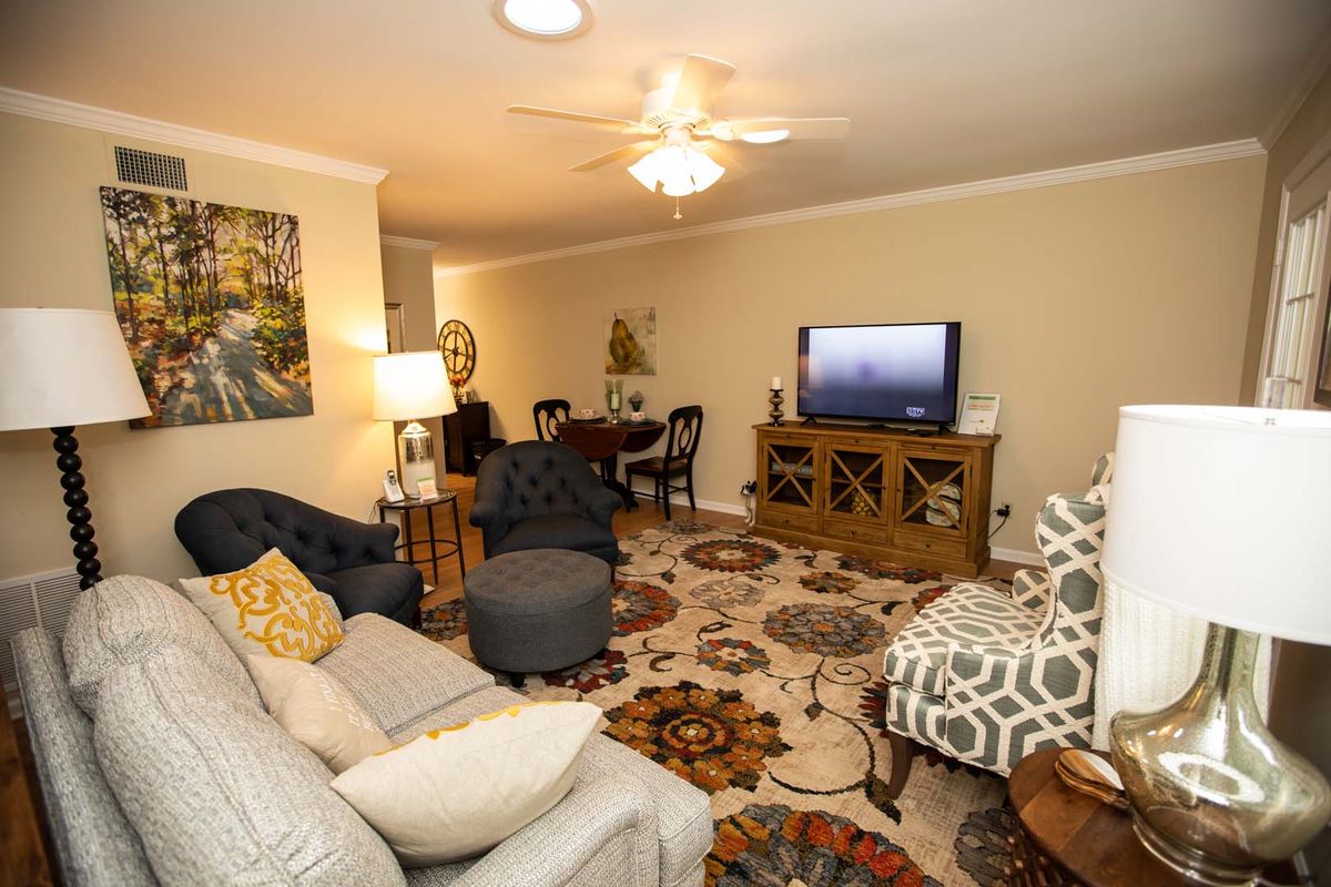 A cozy living room with comfortable furniture and a television.