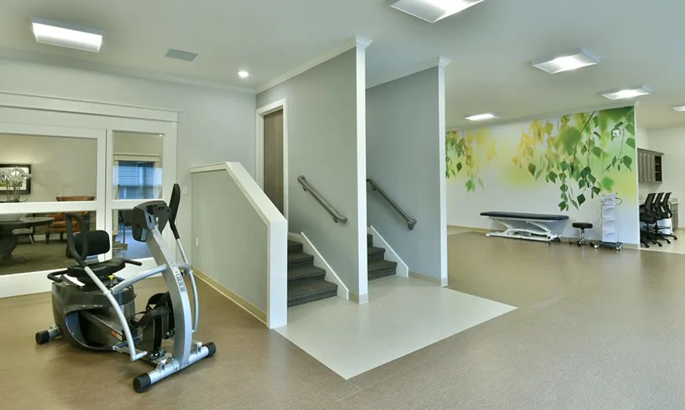 A modern gym interior featuring exercise stairs and fitness equipment.