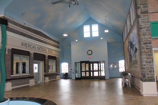 Spacious lobby area of a community center with blue walls and ample natural light.