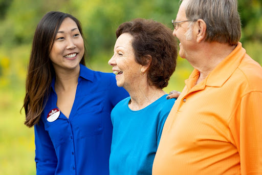 A joyful moment of conversation among friends in a sunny outdoor setting.