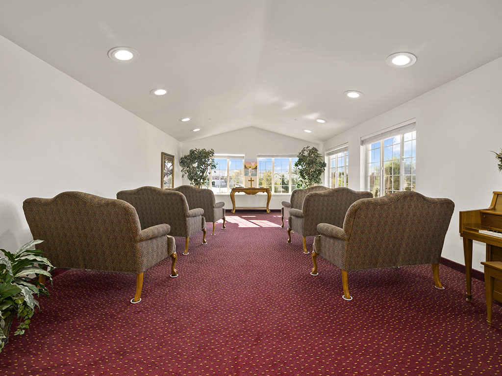 A spacious waiting area with comfortable seating and large windows allowing natural light to fill the room.