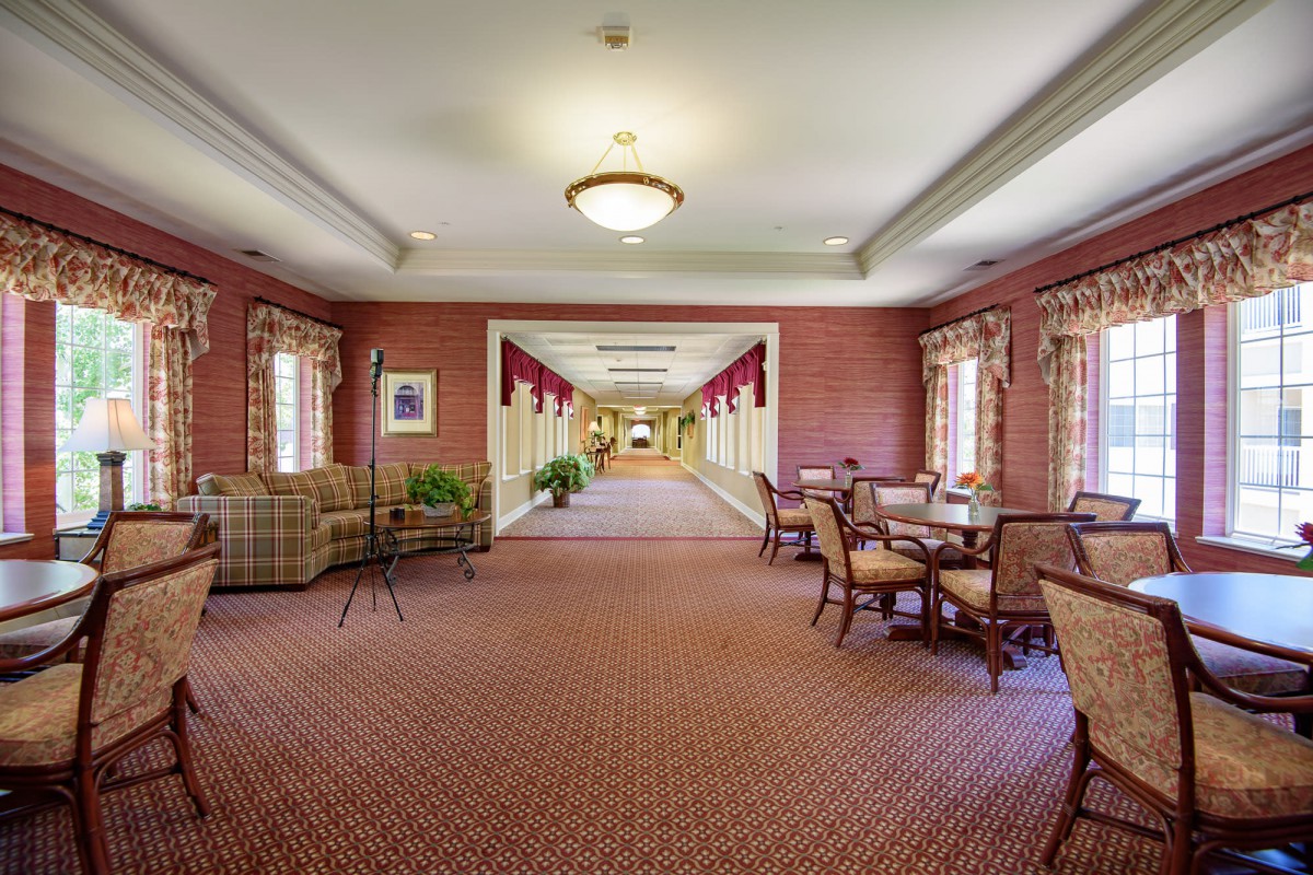 A well-lit hallway with comfortable seating and elegant decor.
