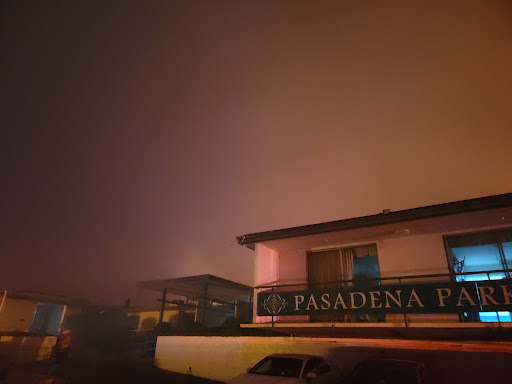 A foggy night view of a building in Pasadena, shrouded in atmospheric haze.