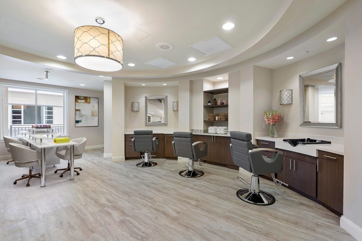A modern and cozy salon interior with multiple haircut stations.