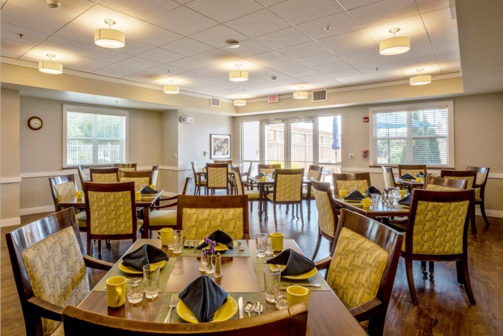 An elegant dining room with neatly arranged tables and chairs, set for a meal.
