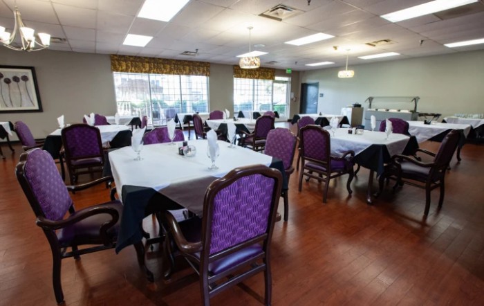 A well-lit dining area with tables set for a meal.