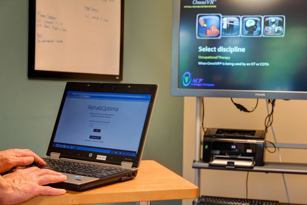 An office setup featuring a laptop and a monitor displaying different screens.
