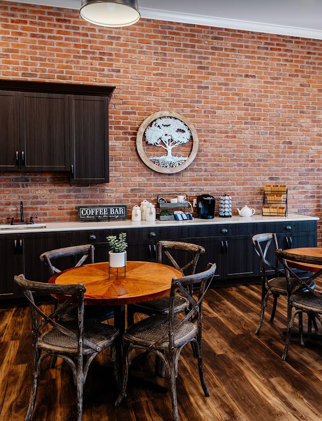 A cozy coffee shop with wooden tables and brick wall decor.