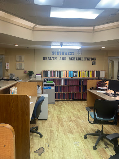 A view of a healthcare rehabilitation office with organized workstations and shelves.