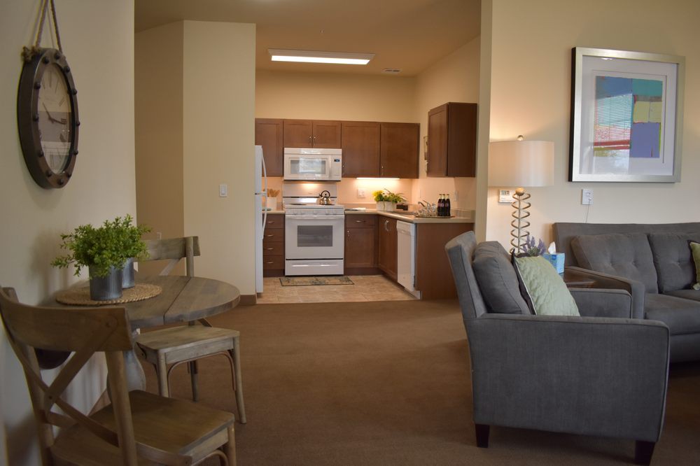 A modern apartment interior with an open kitchen and a cozy living area.