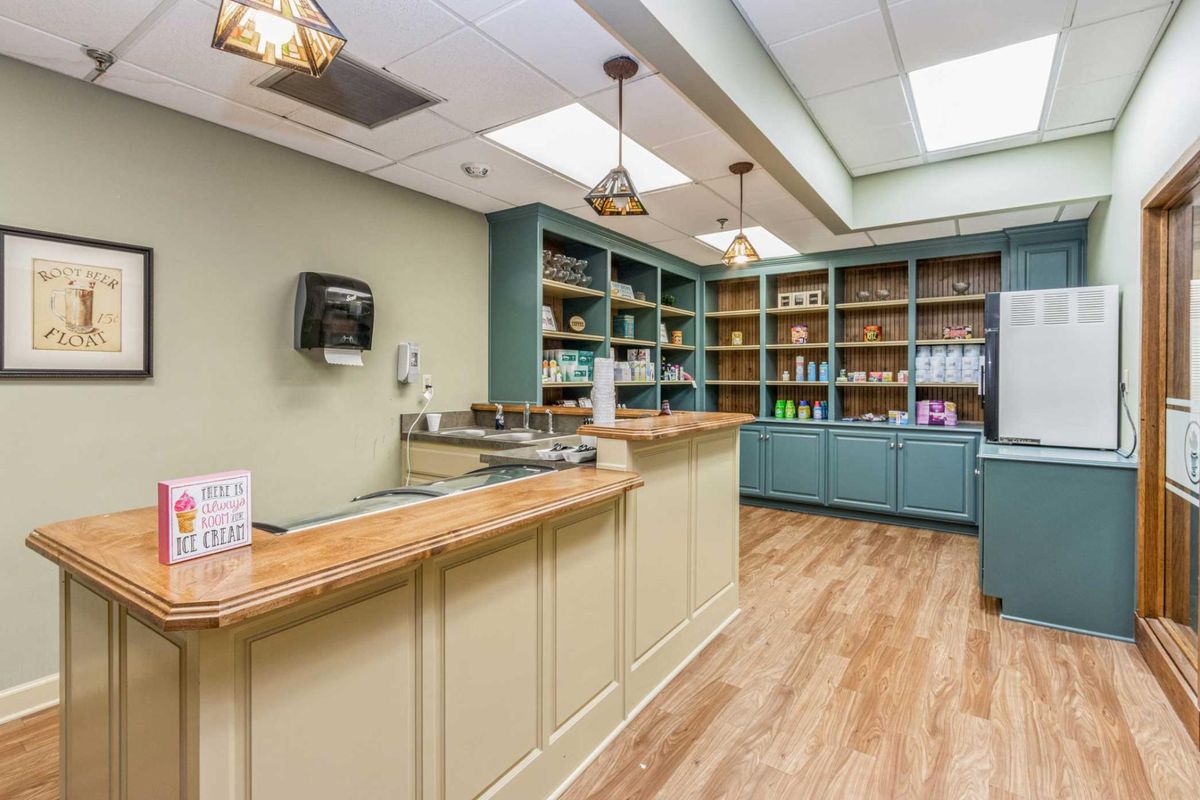 A well-organized shop interior with wooden floors, counters, and shelves filled with products.