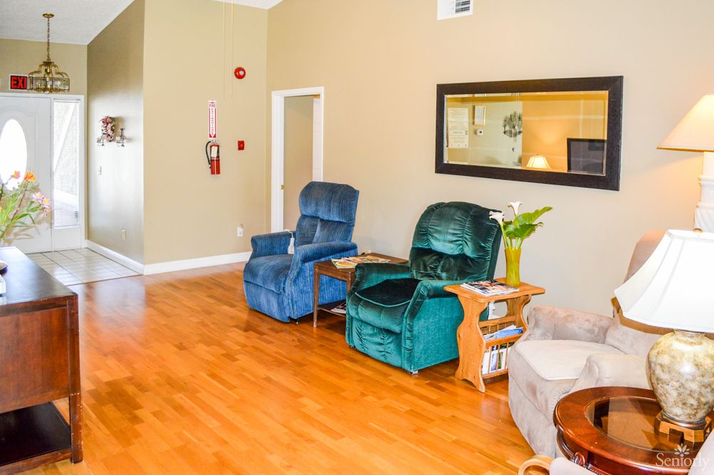A cozy living room with recliner chairs and wooden flooring.
