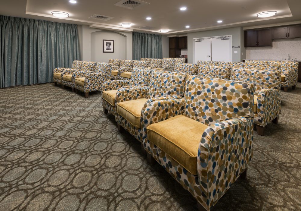 A well-organized seating area with patterned armchairs in a spacious room.