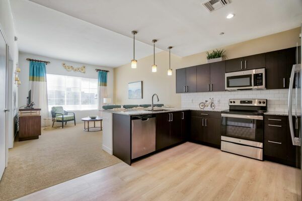 A modern kitchen with stainless steel appliances and an open floor plan.